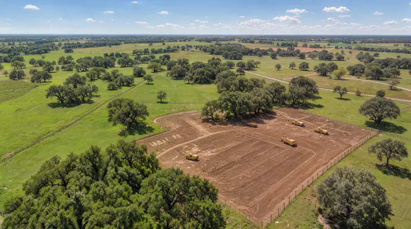 Aerial view of a cleared building site among pasture and oaks, land clearing in Central Texas, Texas